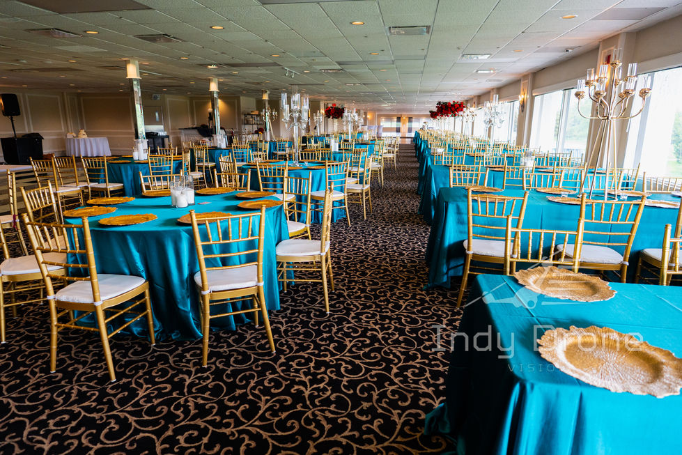 Hanging floral installation above a wedding head table at indoor venue