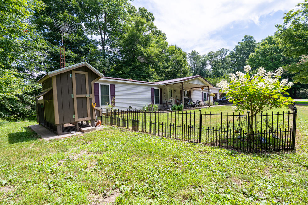 Side yard with large trees in rural Indiana home.