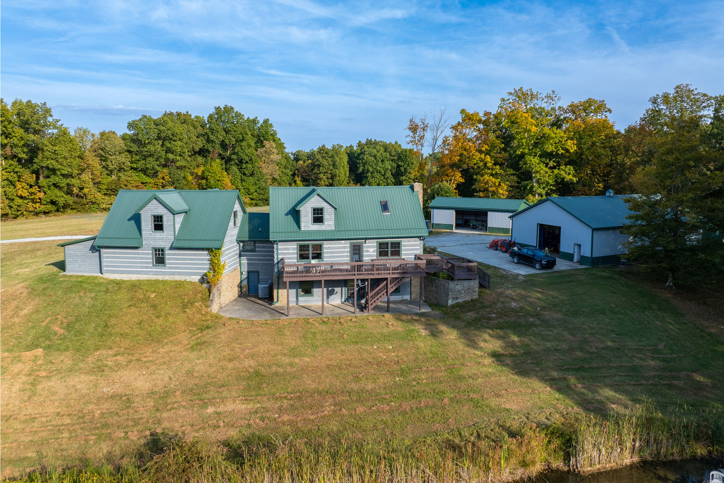 Overhead drone image capturing barns and private airstrip together.
