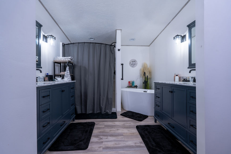 Modern bathroom with double sinks and walk-in shower in Spencer, Indiana.
