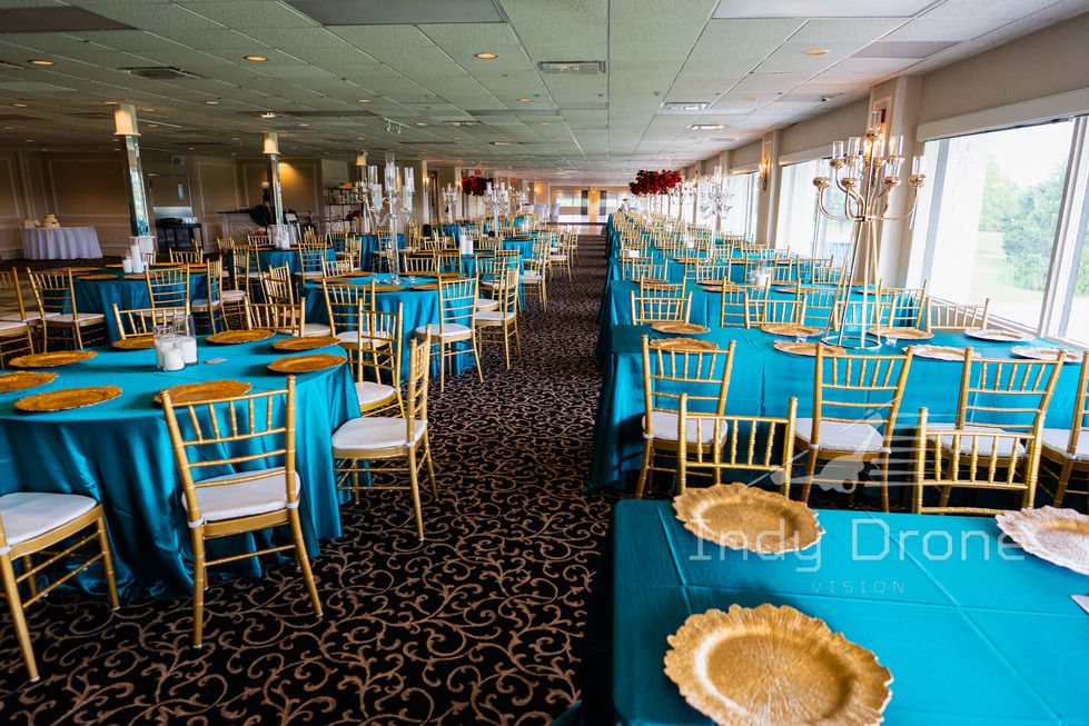 Hanging floral installation above a wedding head table at indoor venue