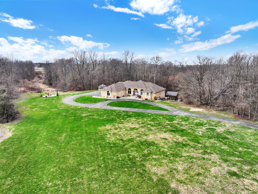 Wide aerial shot of estate home in Central Indiana rural setting