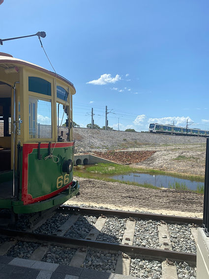 Perth Tram 66 and the Whiteman Park Entrance tram stop with Transperth C series railcar in the background.
