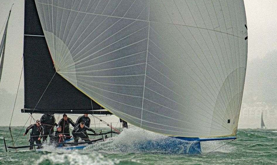 Cape 31 'Aja' planing downwind under spinnaker, sold by 31 North Group