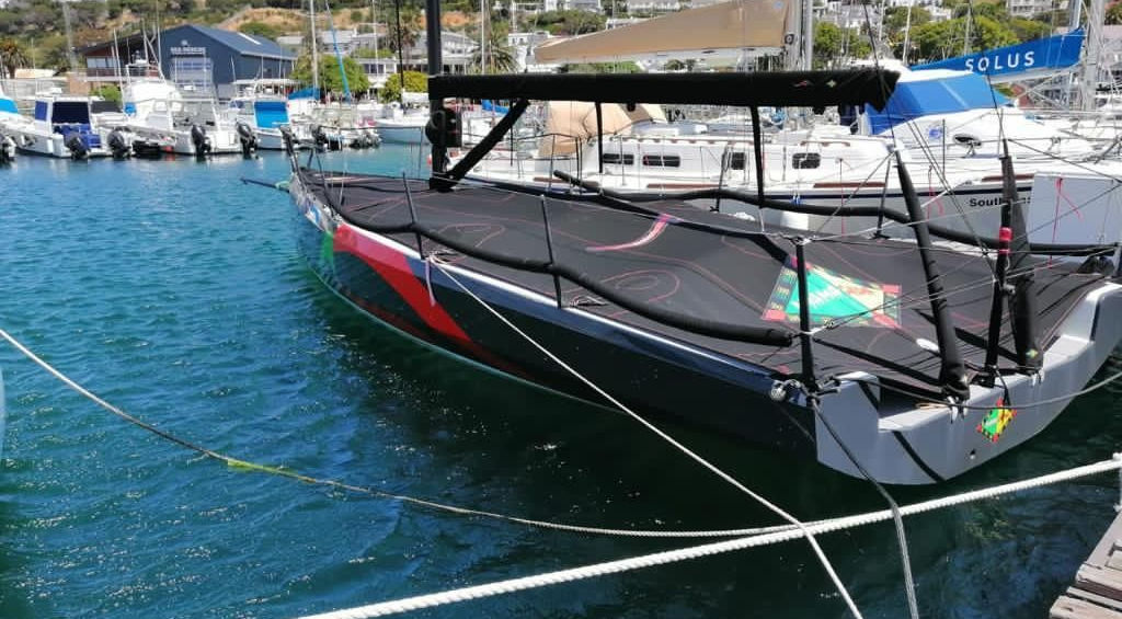 Cape 31 'Nyama Choma' moored in a Cape Town marina under full covers