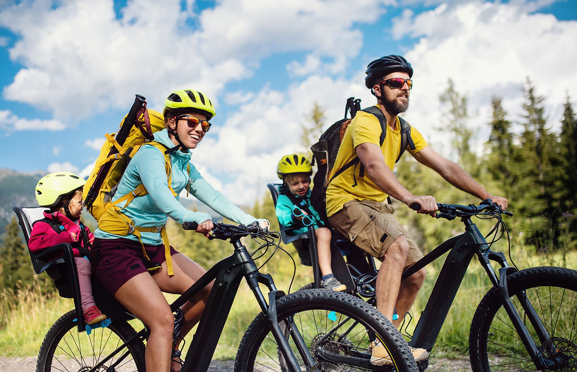 Family with small children cycling outdoors in summer nature, High Tatras in Slovakia..jpg