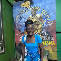 Woman sitting on stool at Okomfo Anorkye sword site