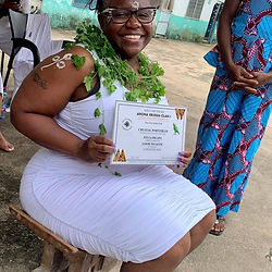 woman sitting on stoll holding certificate