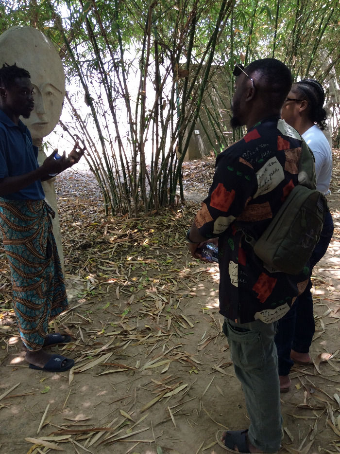 Visitors among trees during an Ada cultural tour in Ghana