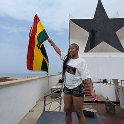Lady waving Ghanaing flag on top of Black star square