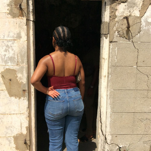 Visitor at a historic stone doorway during an Accra tour