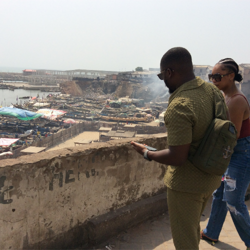 Visitors overlooking a fishing harbour during an Accra tour