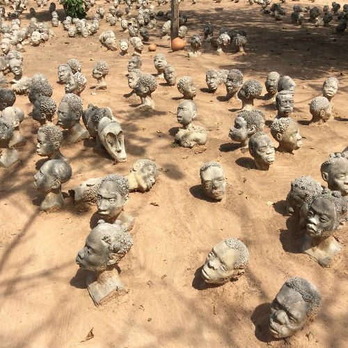 Sculpted heads at Nkyimkyim Museum during an Ada cultural tour