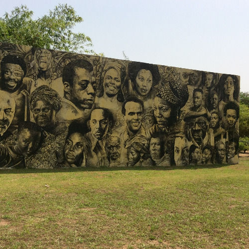 Portrait mural on an outdoor wall at Nkyimkyim Museum in Ada