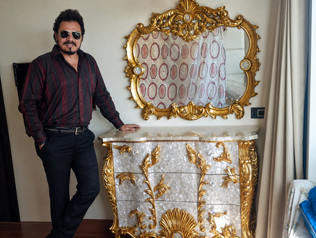 Shehzad Khan applying genuine gold leaf during a professional gilding project at MIDAS TOUCH.