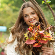 Michigan Senior Portraits Photographer captures candid moments of a senior girl reading under a canopy of trees at the Park in Caro, Michigan.