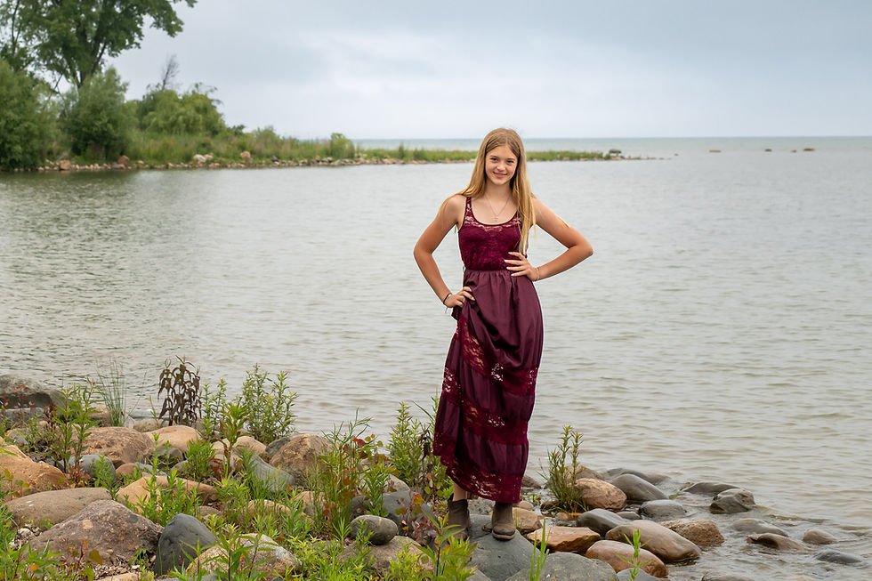 Close-up detail shot of the rich burgundy boho dress fabric blowing gently in the Lake Huron breeze