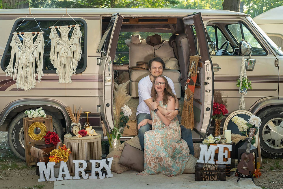 Couple posing with vintage GMC van Mabel near Port Crescent State Park Michigan