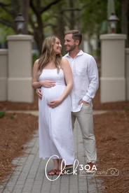 The couple’s silhouettes against the sunset create a dramatic 30A Maternity Portraits scene.