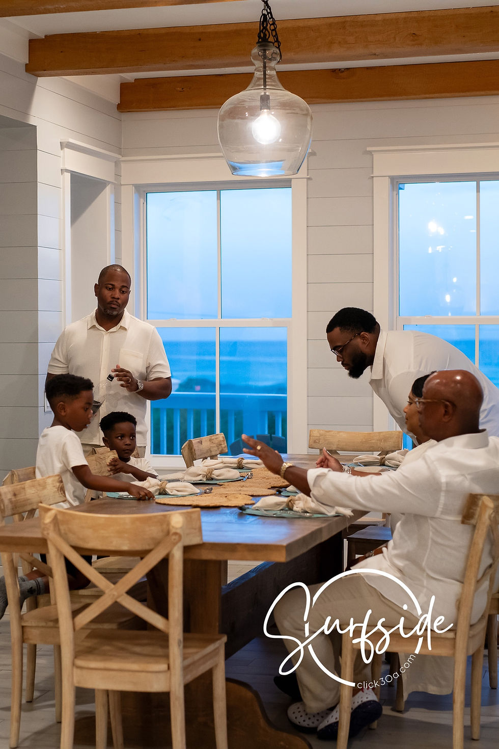 Family of 8 eating dinner and wondering where can I book a beach portrait session in Santa Rosa Beach.