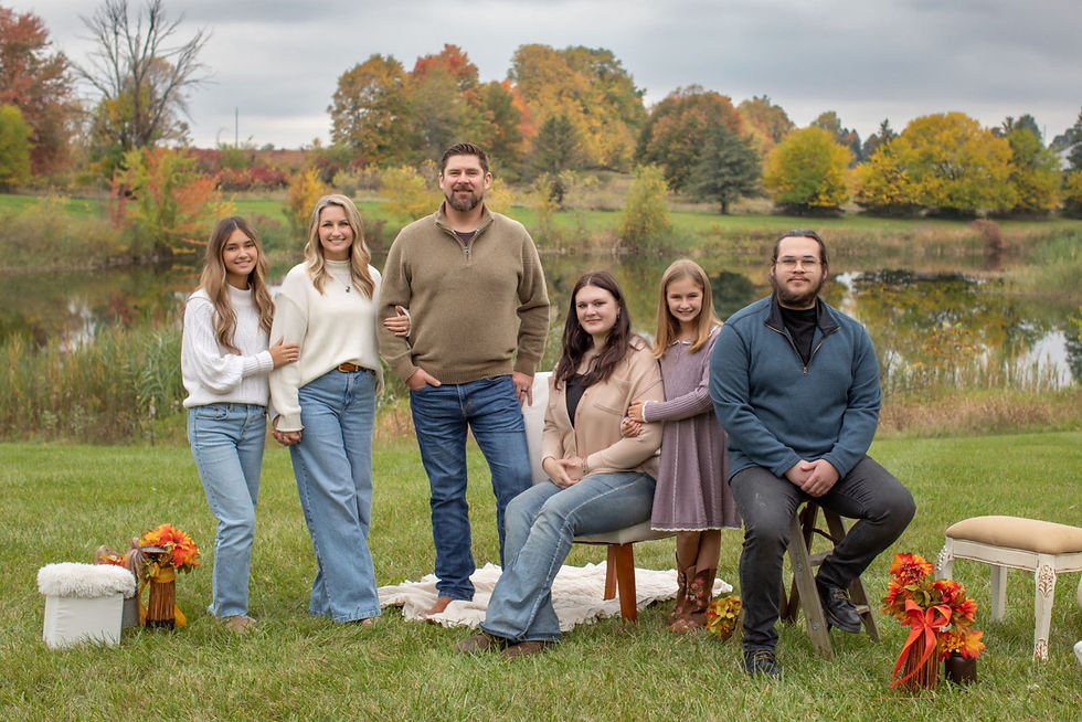 Fall family photos in Cass City Michigan featuring coordinated neutral outfits and beautiful autumn colors.