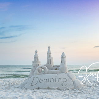 Family portrait with a majestic 4-foot sandcastle as the centerpiece, highlighting the technical skill of photography in Seaside Florida.