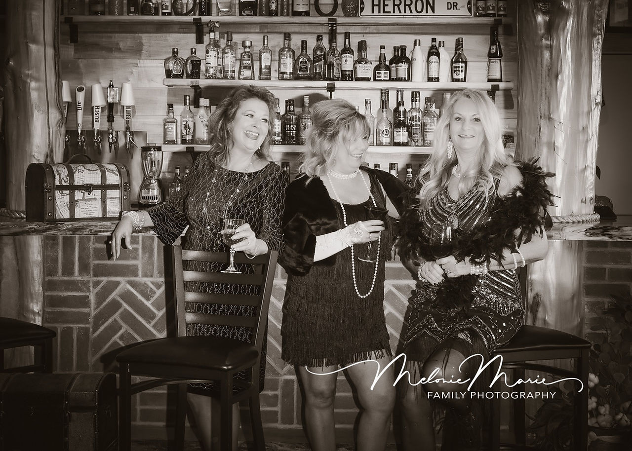Sipping and Smiling. A candid moment reveals the friends sharing a laugh while sipping their drinks. The warmth of their friendship shines through in this playful snapshot.