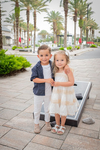 Family of four enjoying a beach portrait session with one of the best family portrait photographers in the 30A area.
