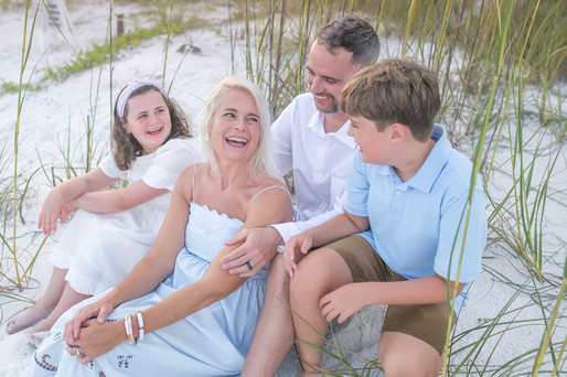 Family laughing together during golden hour near Seagrove Beach, where to buy heirloom art photography prints in 30A Florida.