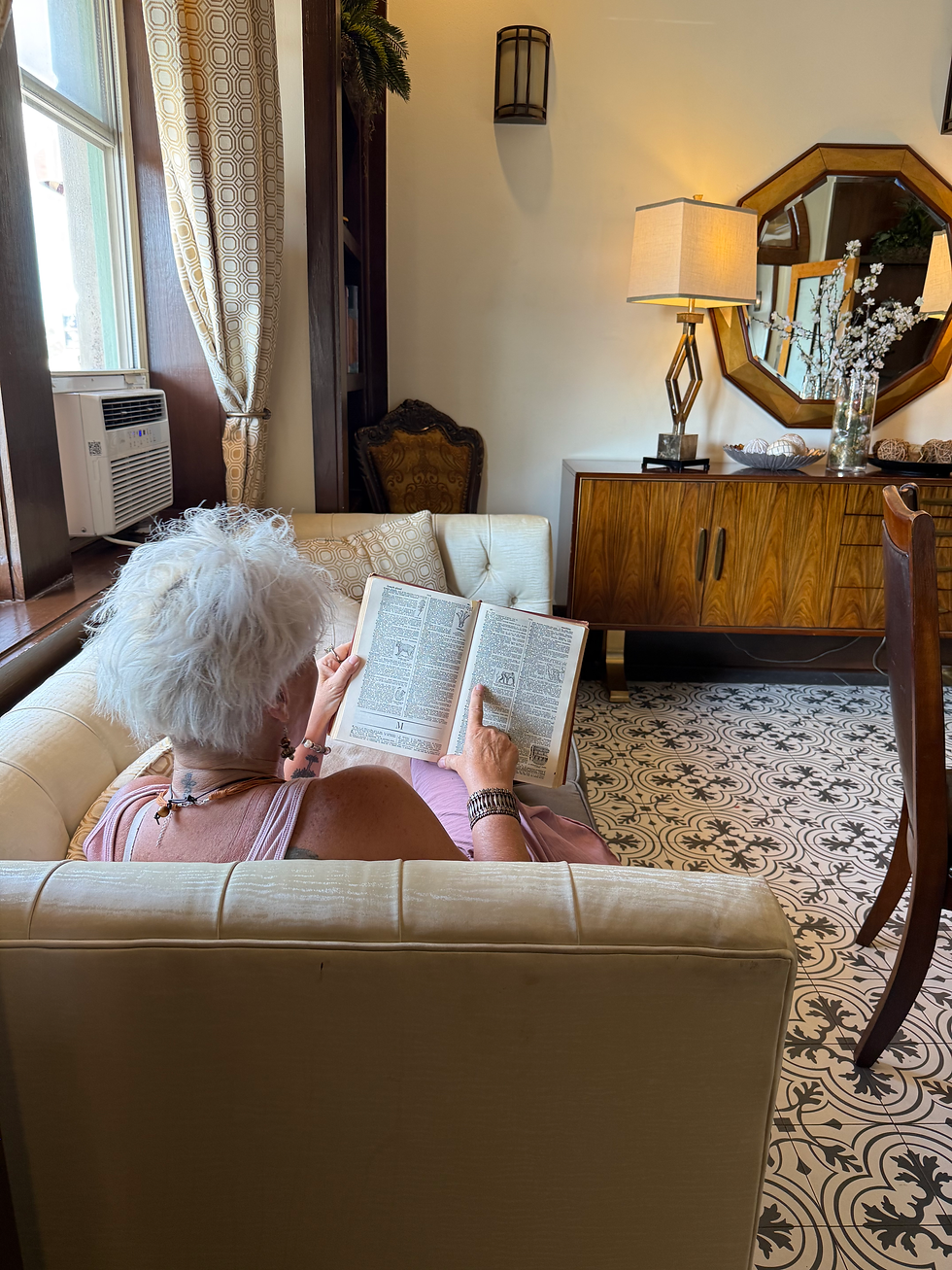 A quiet luxury moment of someone reading a book in a beautiful library, embracing knowledge and becoming their future self