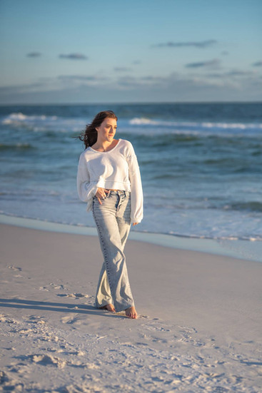 Professional photographer creating stunning solo beach portraits along the white sand beaches of Panama City Beach.