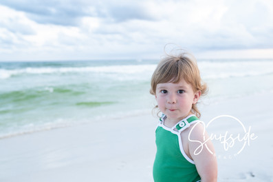 Candid shot of a family walking on the beach, by a 30A Photographer.