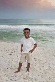 Couple with child during a 30A Photo Mini Session on the dunes — book quick family portraits while on vacation in 30A; Click 30A Photography is an experienced and professional photographer.
