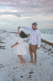 Family enjoying a barefoot walk on the beach while learning where to buy heirloom art photography prints in 30A Florida.