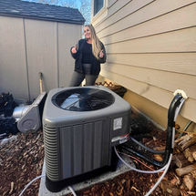  A happy customer giving thumbs-up next to a newly installed air conditioning unit outside their home.