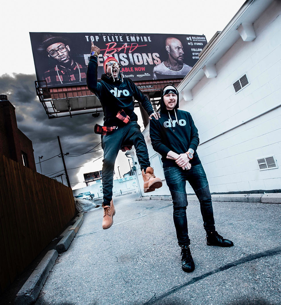 Top Flite Empire poses in front of their Bad Decisions billboard in Denver, featuring Hypnautic and King Tef promoting their album