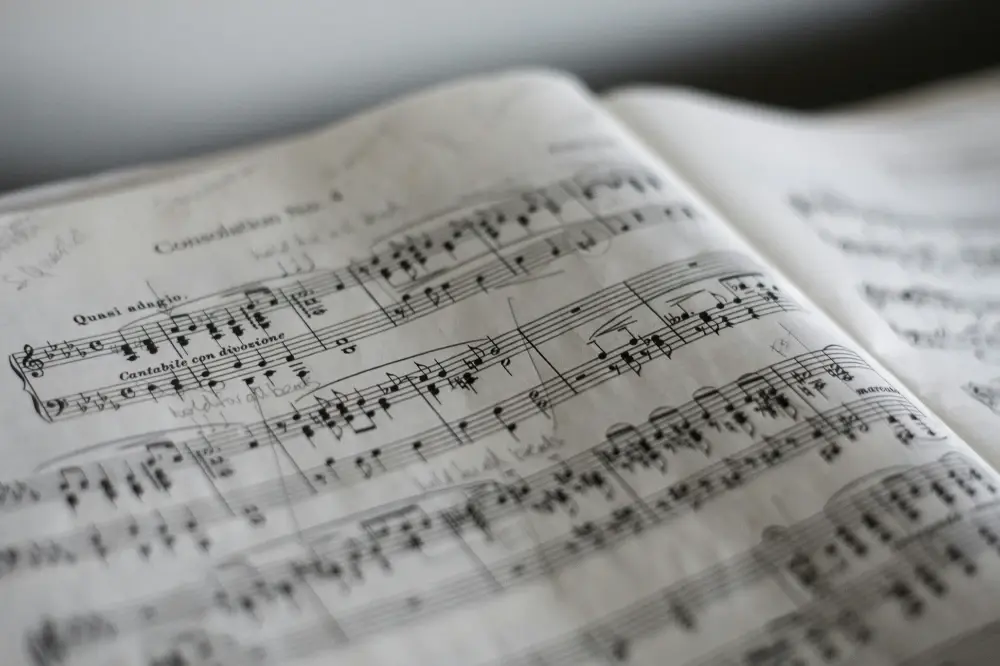 Open sheet music shows handwritten notes and annotations across the printed score.