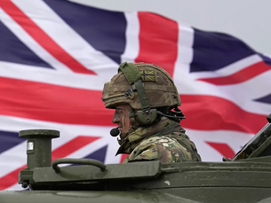 British trooper on a tank with the Union Flag