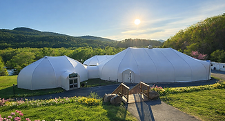 Springtime tents in lush landscape.png