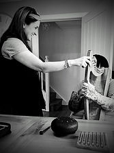black and white photo of music therapist with a client playing small harp