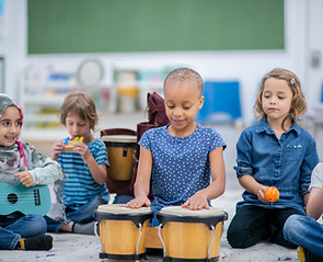 children playing music neeling on floor