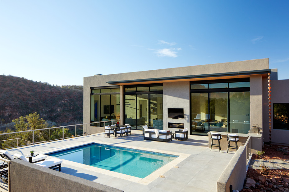 Sedona luxury pool terrace with modern outdoor furniture built in fireplace and canyon views