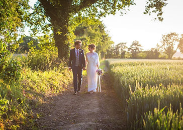 Bride and Groom in Npwalking in the Norfolk countryside