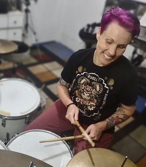 Female adult student practices a drumset rhythm while in a drum lesson studio
in St. Louis, MO