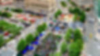 Aerial view of a crowded city plaza festival with tents, food trucks, trees, and tall buildings surrounding busy streets. expedition detroit best outdoor experiences near detroit michigan summer 2026 races festivals events adventures guided tours great lakes campus martius downtown fifa world cup watch party