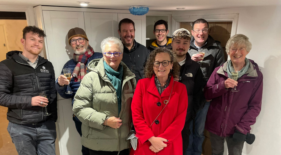 A photo of the Iconic Team gather together, celebrating.