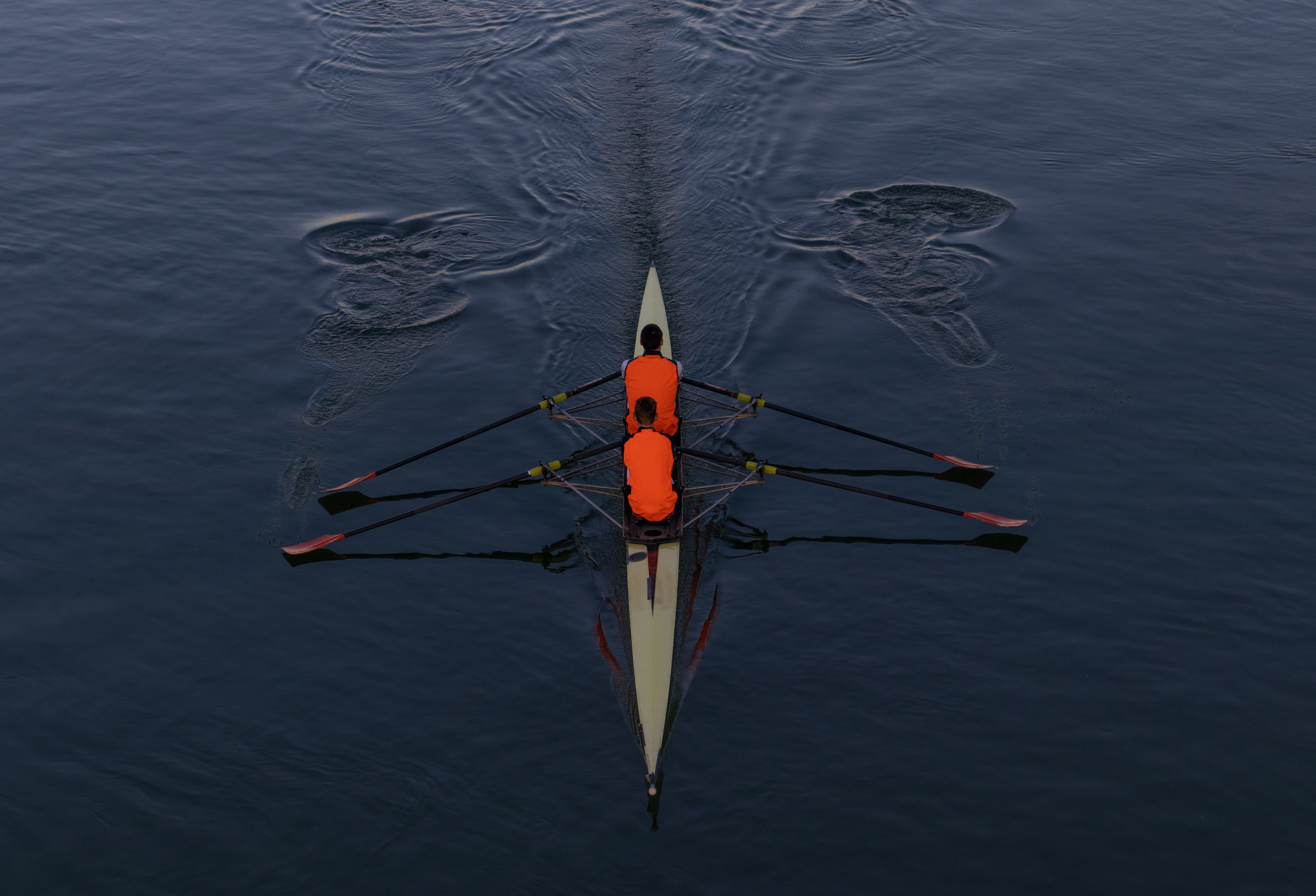 high-angle-shot-two-people-paddling-boat-middle-sea.jpg