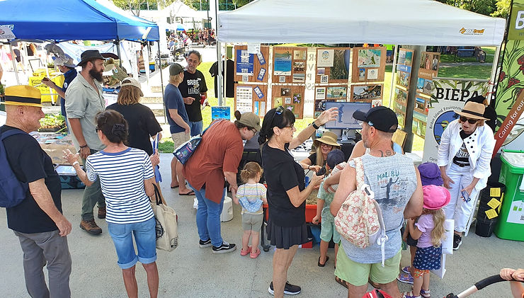 people gathering around market stall