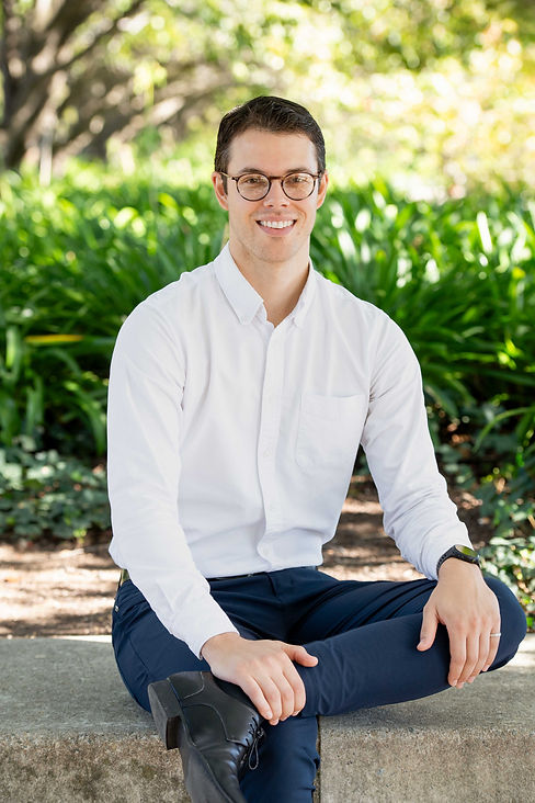 Alex Sitting Headshot (wide).jpg