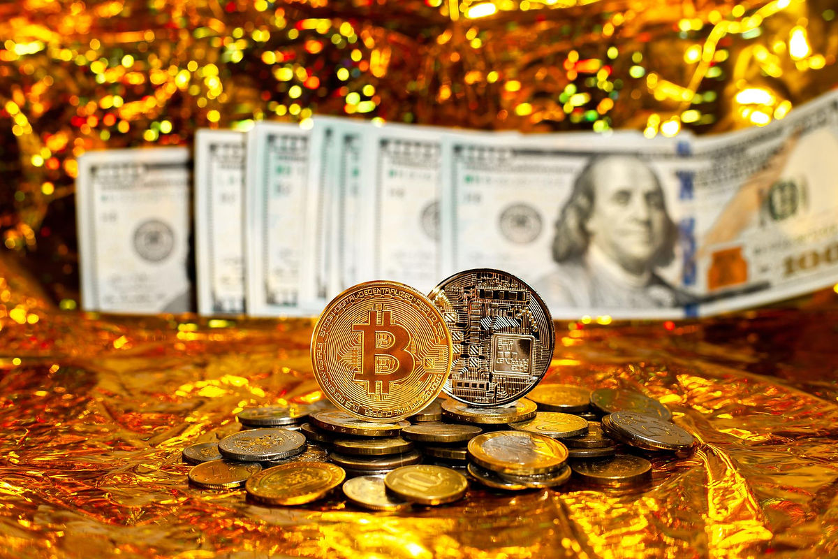two-bitcoins-stack-coins-against-background-hundreddollar-bills-arranged-fan-golden-backgr
